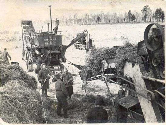An archival photograph of farm machinery and workers illustrating the Kaltuk settlement history. The publication does not specify the year or identify the people.