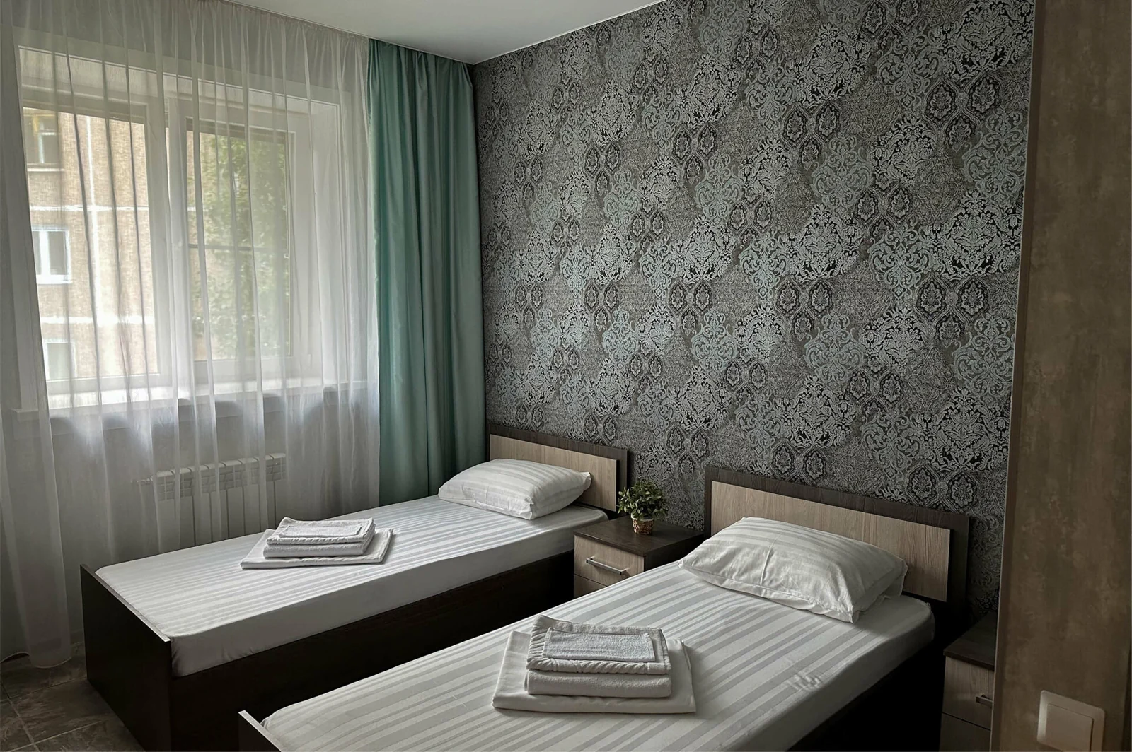 An official photograph from Tri Kita, 3A Deputatskaya Street, showing one accommodation option.